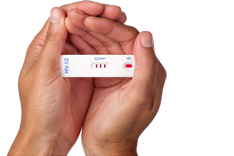 Hands holding HIV test. 