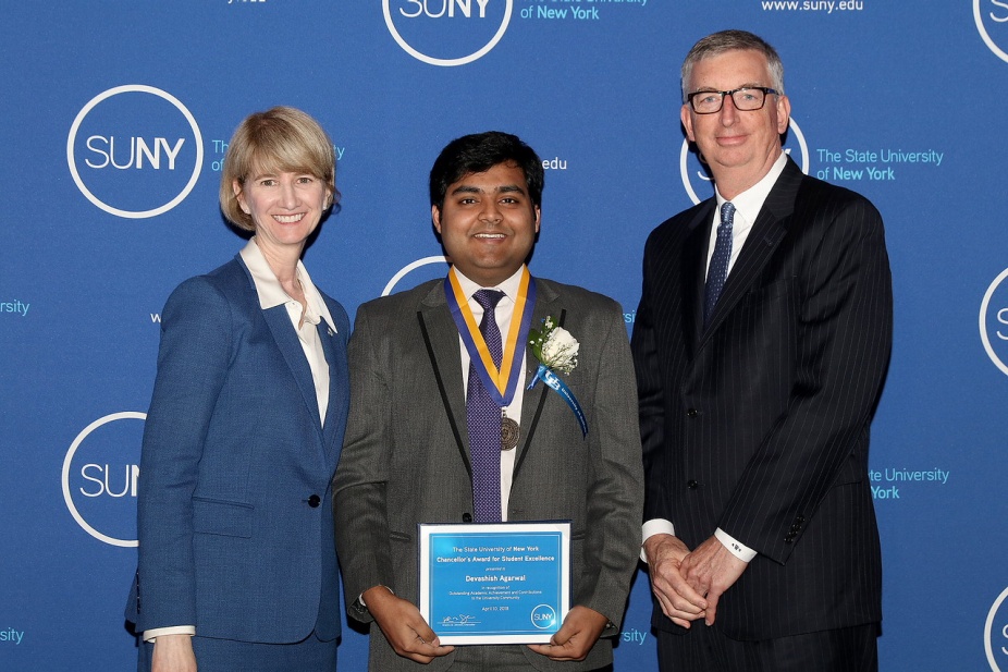 SUNY Chancellor Kristina Johnson (left) and UB Vice President for Student Life A. Scott Weber (right) congratulate Devashish Agarwal. 