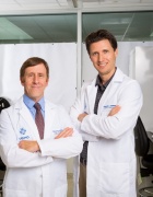 Bruce Troen, left and Ken Seldeen, in white coat in lab. 