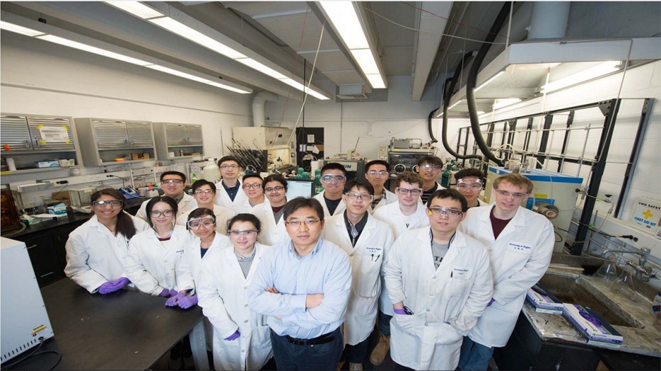 Gang Wu, front and center with arms crossed, in his lab with his students. Credit: Onion Studio. 