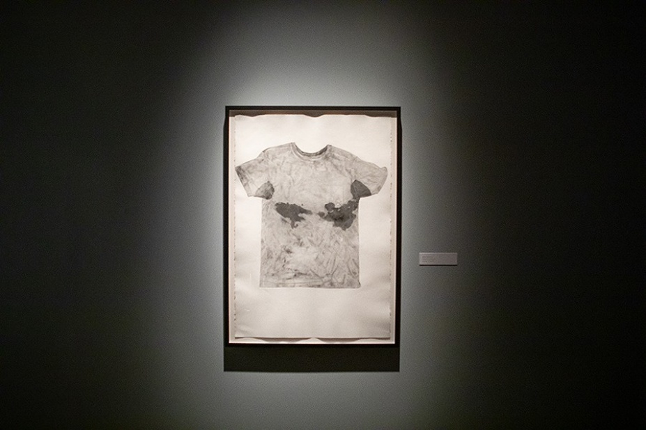 Sweat-stained t-shirt framed on wall.