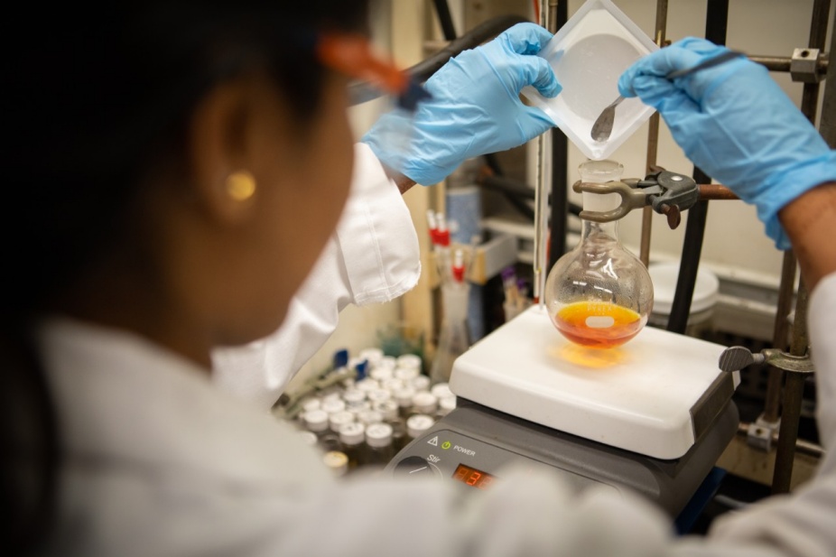 Zoom image: UB chemistry PhD student Karthika Kadassery mixes reagents to prepare a manganese-based precatalyst in the lab of UB chemist David Lacy. Credit: Douglas Levere / University at Buffalo 