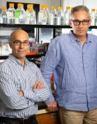 Researchers standing in lab. 