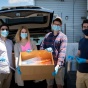 (l to r) Jordan Levine, Brittany Russo, Mitch Eyerman and Joshua Broden hold a box of face shields they made before loading it into a car. 