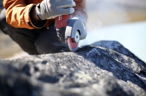 Zoom image: Scientists collect samples from boulders in Greenland. These samples contain chemical isotopes that can help scientists determine the ancient boundaries of the ice sheet. Credit: Jason Briner 