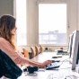 Young female student in computer lab. 