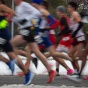 Blurred image of cross country runners running. 