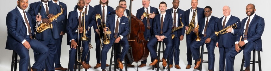 Jazz at Lincoln Center Band Group Photo with instruments and a white background. 