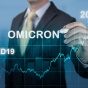 Omicron trendong data on chart form featuring a line chart in the foreground with a person writing the word "omicron" in the background. 