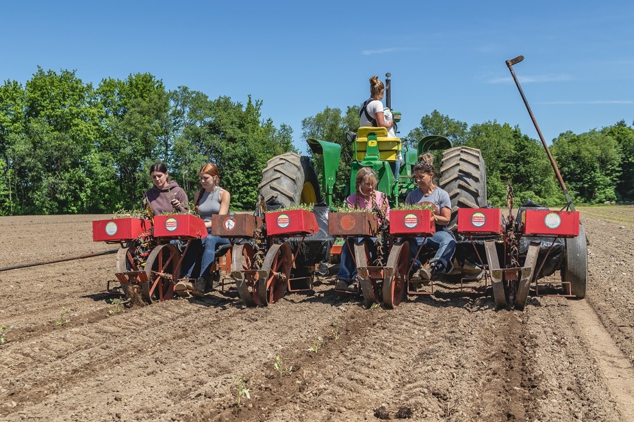 Farm workers on a tractor. 